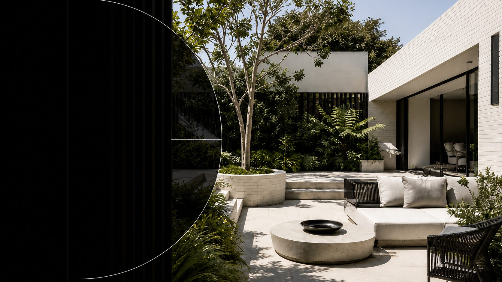 A modern courtyard garden with a sculptural fire pit, mature tree and built-in seating